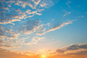 Fototapeta na wymiar Beautiful sunrise sky with bright colors of nature, blue sky with orange sun and beautiful clouds.