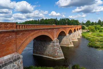 Fototapeta premium Kuldiga Old Bridge-the widest waterfall in the Baltics on the River Venta and Ventas Rumba Waterfall