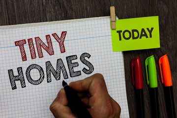 Conceptual hand writing showing Tiny Homes. Business photo text houses contain one room only or two and small entrance Cheap Man holding marker notebook clothespin markers wooden table