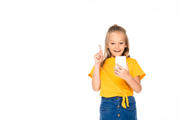 cheerful child showing idea gesture while using smartphone isolated on white