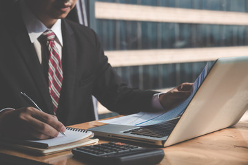 Business man working at office with laptop and documents on his desk, consultant lawyer concept