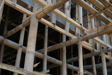 Strong bamboo frame help prop up concrete on under construction home building