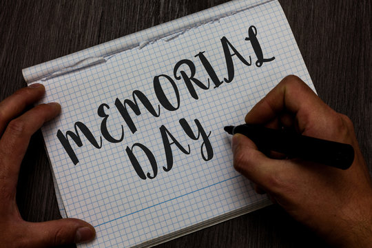Writing note showing Memorial Day. Business photo showcasing To honor and remembering those who died in military service Man hand holding marker communicating ideas reflections squared paper
