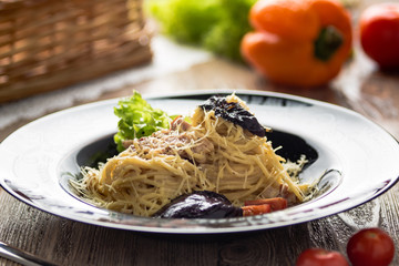spaghetti on a plate with cheese and herbs