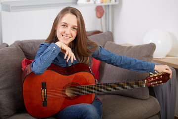 woman play guitar at home