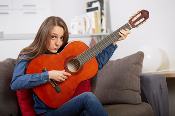 Fototapeta premium woman play guitar at home