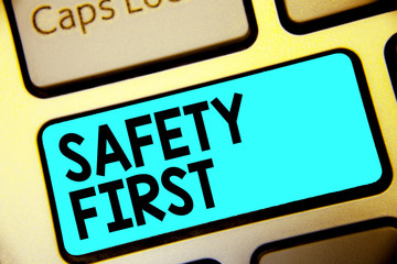 Writing note showing Safety First. Business photo showcasing Avoid any unnecessary risk Live Safely Be Careful Pay attention Keyboard blue key Intention computer computing reflection document