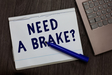 Conceptual hand writing showing Need A Brake question. Business photo text More Time to Relax Chill Out Freedom Stress Free Open notebook squared page black marker computer wooden background