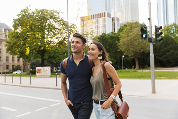 Beautiful lovely young couple walking at the city streets