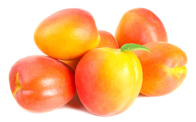apricot fruits with slices and green leaf isolated on white background