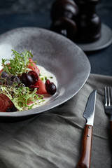 Summer salad made of watermelon, strachatella cheese, fresh mint leaves and micro greens. Top view with copy space.