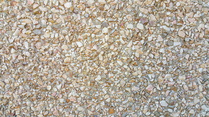 surface structure created by spraying, sand sifted painted crimson and cream small stones, gravel walls, building facades, the medium texture