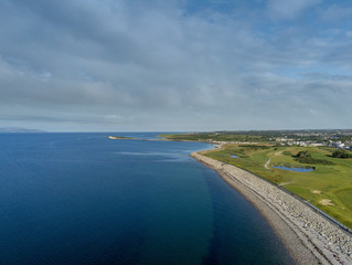 Blackrock diving tower, Salthill promenade, Galway city, Aerial top view. Sunny warm day. People are swimming in the Atlantic ocean.