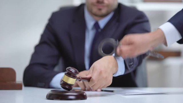 Venal judge handcuffed when passes unfair sentence, instant punishment for bribe