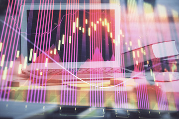 Financial chart drawing and table with computer on background. Double exposure. Concept of international markets.