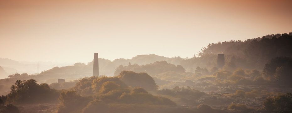 Engine houses from the industrial revolution in the mist at dawn.