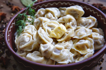 Dumplings, filled with meat, ravioli, pelmeni. Dumplings with filling. Bowl of tasty dumplings. Homemade meat dumplings - russian pelmeni
