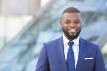 Fototapeta premium Confident Afro Businessman Smiling And Looking At Camera Outdoor