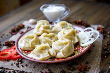 Dumplings, filled with meat, ravioli, pelmeni. Dumplings with filling. Bowl of tasty dumplings. Homemade meat dumplings - russian pelmeni