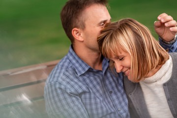 Fototapeta premium Happy young couple hugging and laughing together in the park