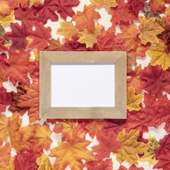 Naklejka na ściany i meble Top view frame on leaves background