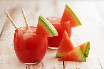Watermelon drink in glass and watermelon balls. A refreshing summer cocktail