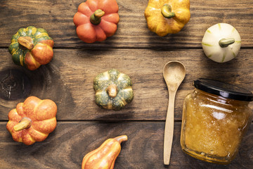 Flat lay pumpkins arrangement  with jam jar and spoon