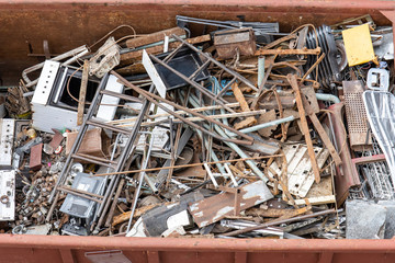 pile of old rusty scrap metal in a container