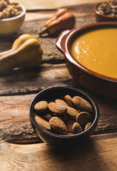 High angle assortment with almonds, soup and pumpkin