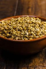 Close-up bowl with dried chamomile flowers