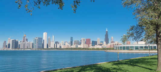 Panoramic Chicago downtown buildings and mature trees in foreground along Michigan Lake