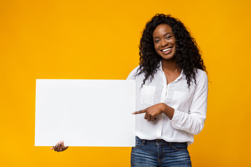 Afro girl is holding yellow advertising board