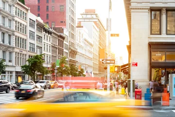Foto op Aluminium New York City street scene with yellow taxi cab driving down 5th Avenue through Midtown Manhattan © deberarr