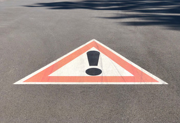 Warning sign painted on the road