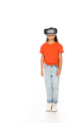 full length view of smiling african american kid using virtual reality headset on white background