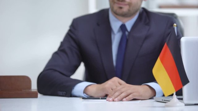 German consular officer giving passport to woman, refugee visa, asylum status