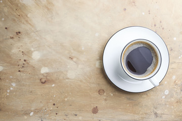 Cup of coffee on beige stone table in minimal style