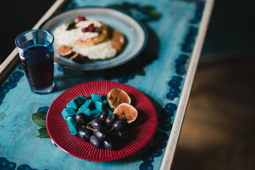 Tasty and delicious breakfast with pancakes, cheese and fruit for a bride in the morning.