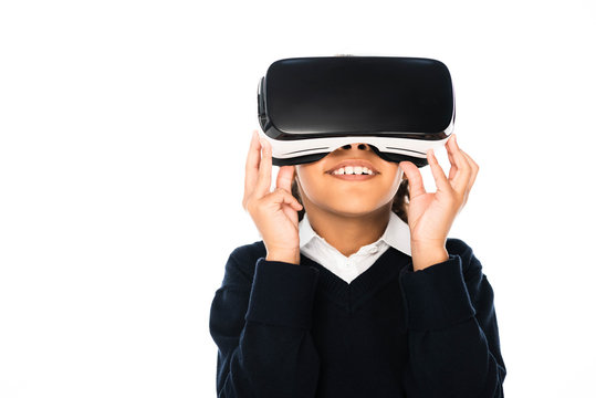 smiling african american schoolgirl using virtual reality headset isolated on white - Powered by Adobe