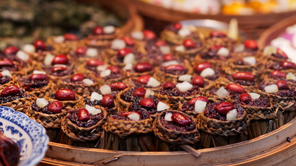 Close up of delicious Chinese rice cake made by jujube, sugar and black glutinous rice, steamed food.