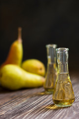 Rakia, rakia, fruit brandy drink and pears on wooden background