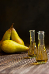 Rakia, rakia, fruit brandy drink and pears on wooden background