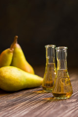 Rakia, rakia, fruit brandy drink and pears on wooden background