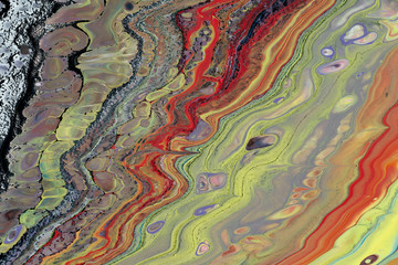 Blurred abstract background. Mixing different colors of paint. Cropped shot, horizontal, close-up, no people, free space. Design concept.