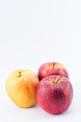 three apples on a white surface - natural nutrition concept