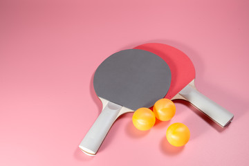 Table tennis or ping pong Sport concept . Two Rackets and ball on Pink background . Indoor sport...