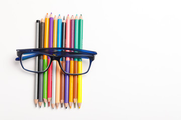 The concept of the teacher's day, School stationery, pencil, pen, note, Spectacles, tie in pen box on white background