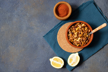 Prebranac Balkan baked beans. Serbian, Montenegrin, Bosnian, Croatian and Slovenian cuisine. Baked  beans, lemon, paprika powder. Dark background. Top view. Space for text