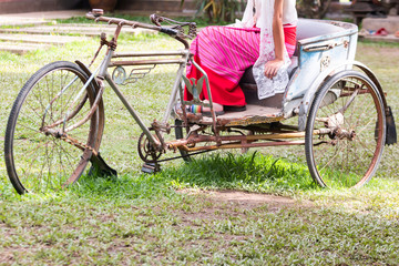 Fototapeta na wymiar Ancient tricycle In the old house of Thailand