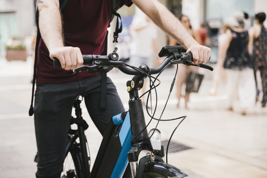 Cyclist Riding E-bike Through City